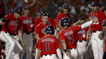 The Mississippi bench comes out to celebrate a two-run home run by Peyton Chatagnier (1) against Arizona during the second inning of an NCAA college baseball tournament super regional game Saturday, June 12, 2021, in Tucson, Ariz. (Kelly Presnell/Arizona Daily Star via AP)