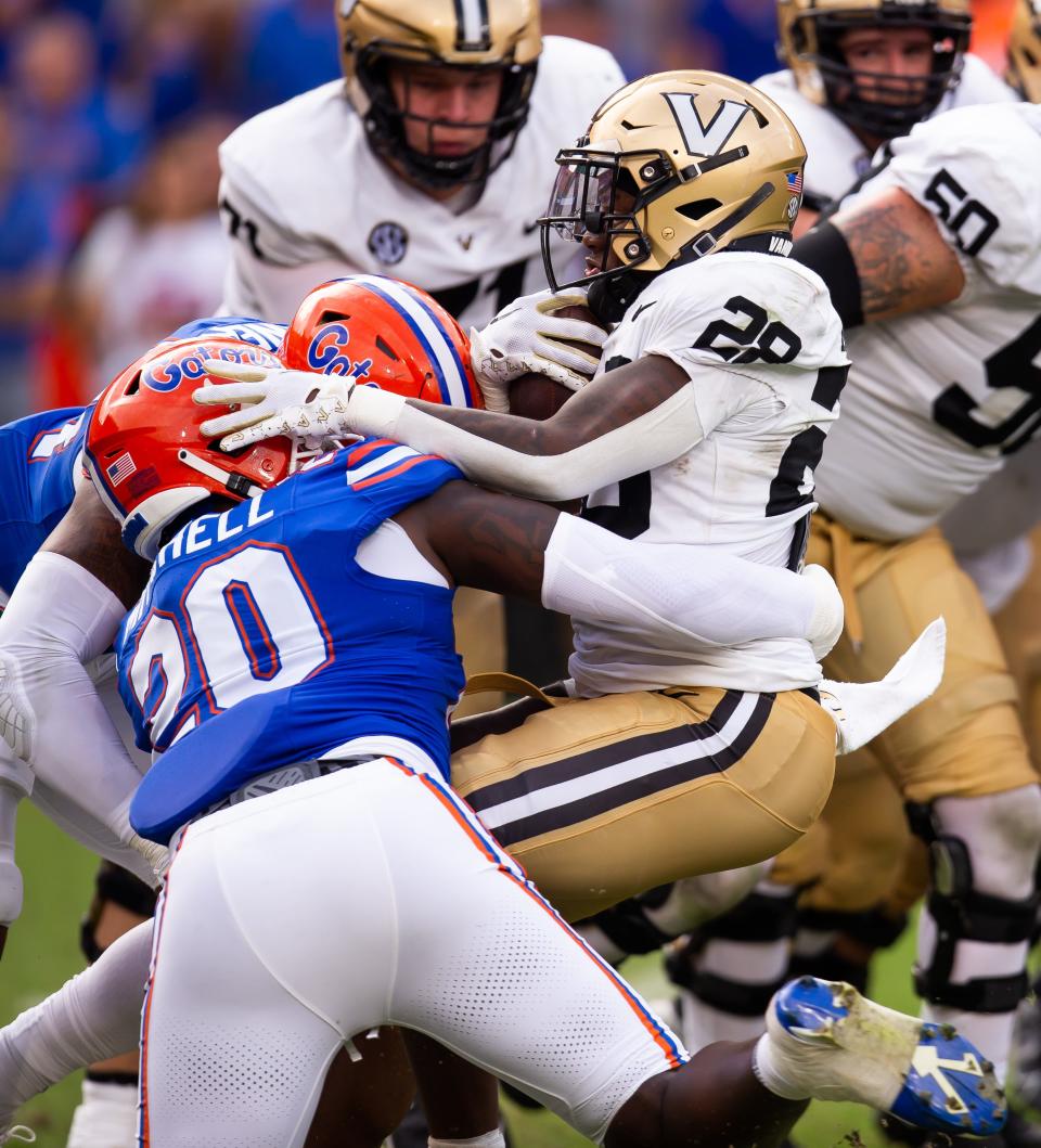 Florida Gators linebacker Teradja Mitchell (20) tackles Vanderbilt Commodores running back Sedrick Alexander (28) in the first half at Steve Spurrier Field at Ben Hill Griffin Stadium in Gainesville, FL on Saturday, October 7, 2023. [Doug Engle/Gainesville Sun]