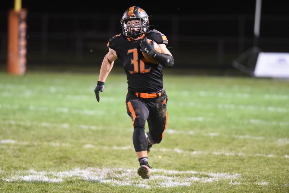 Almont's Chase Battani carries the ball during a Division 6 regional final against Detroit Edison at Almont High School on Friday, Nov. 10, 2023.