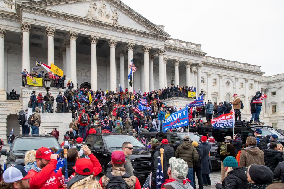 Rioters swarm the U.S. Capitol building following a Trump  protest in Washington, DC on Jan. 6, 2021.