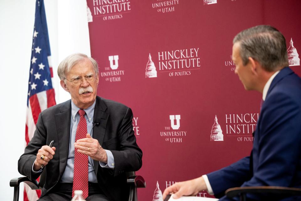 John Bolton, former national security adviser and U.S. Ambassador to the United Nations, left, speaks with Jason Perry,