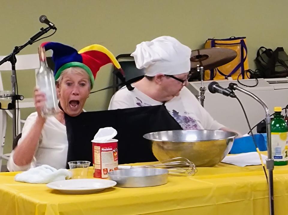 Sandie Pierce, director of the Monroe Center for Healthy Aging (left), and Mary Rhoades were Siamese twins in the center's recent talent show, which featured 12 acts. The women demonstrated how to make a rum cake. "Step one: Taste the rum to make sure it's OK," Pierce said.