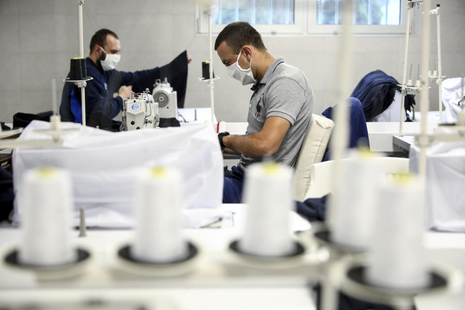 Inmates produce medical protection equipment in Zenica, Bosnia, on Nov. 23, 2021. In the early days of the pandemic and Bosnia was facing shortages of personal protective equipment, inmates in Zenica were offered to take up sewing protective face masks and other items as part of the prison's work program. (AP Photo)