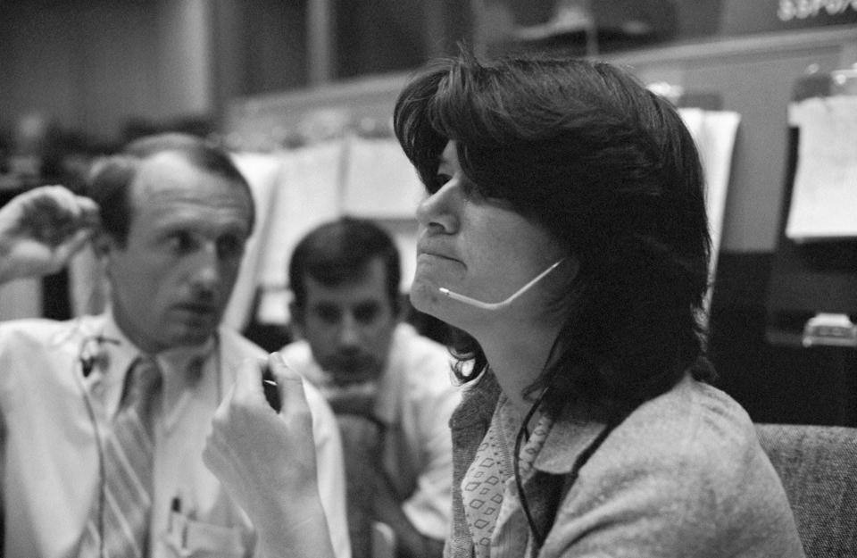 Astronaut Sally Ride at the CapCom console during the STS-2 simulation in 1981. She appears to be speaking to the crew using a headset.