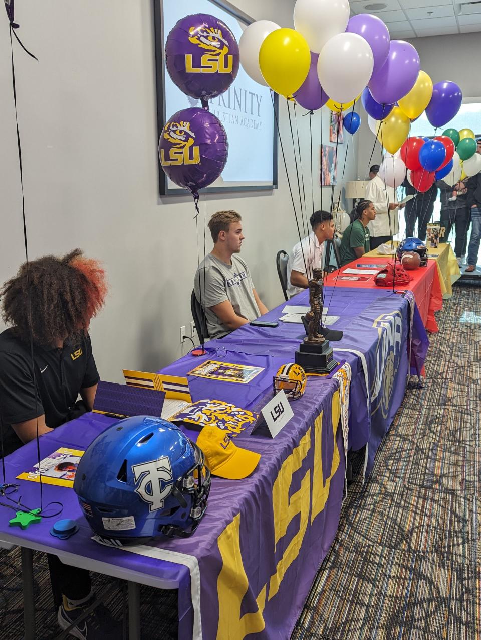 Trinity Christian quarterback Colin Hurley (LSU), long snapper Braden Forscutt (North Alabama), wide receiver Kyle Boylston (FAU) and wide receiver Miles Burris (Charlotte) line up to sign college football letters of intent on Wednesday morning.