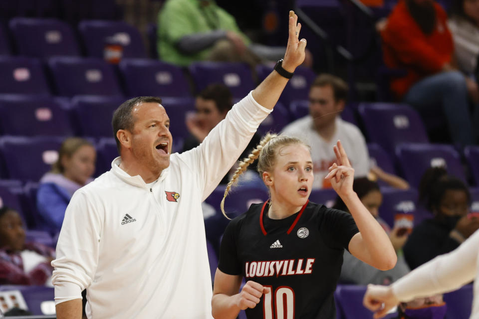 FILE - Louisville head coach Jeff Walz, left, and guard Hailey Van Lith direct their team against Clemson in the third quarter of an NCAA college basketball game in Clemson, S.C., Thursday, Feb. 3, 2022. Over 1,200 women’s basketball players entered the portal last year for various reasons and just over 1,000 found new schools to play at according to the NCAA. The Cardinals took a hit when star guard Hailey Van Lith entered the portal and ended up at defending champion LSU. (AP Photo/Nell Redmond, File)