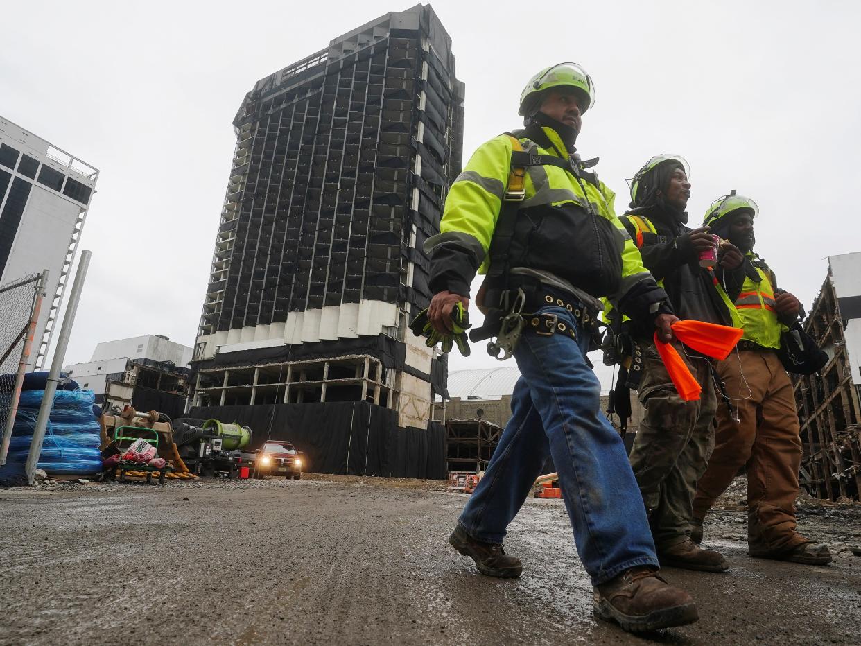 <p>Workers leave the site of the Trump Plaza Casino that is scheduled for implosion tomorrow in Atlantic City, New Jersey, US, 16 February, 2021</p> (REUTERS)