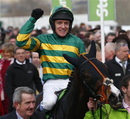 Barry Geraghty on Jezki celebrates as he enters the winners enclosure after winning the Champion Hurdle Challenge Trophy at the Cheltenham Festival horse racing meet in Gloucestershire, western England March 11, 2014. REUTERS/Eddie Keogh