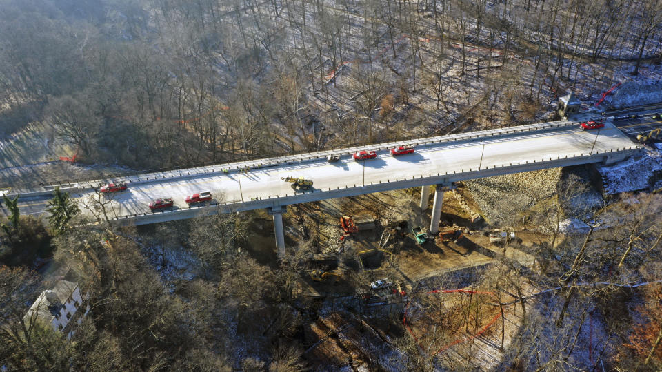 This aerial image taken with a drone, shows the new Fern Hollow Bridge, that is being dedicated Wednesday, Dec. 21, 2022 in Pittsburgh. After the original bridge collapsed into a ravine on Friday, Jan. 28, 2022, the Fern Hollow Bridge became a symbol of the country's troubled infrastructure. (AP Photo/Gene J. Puskar)