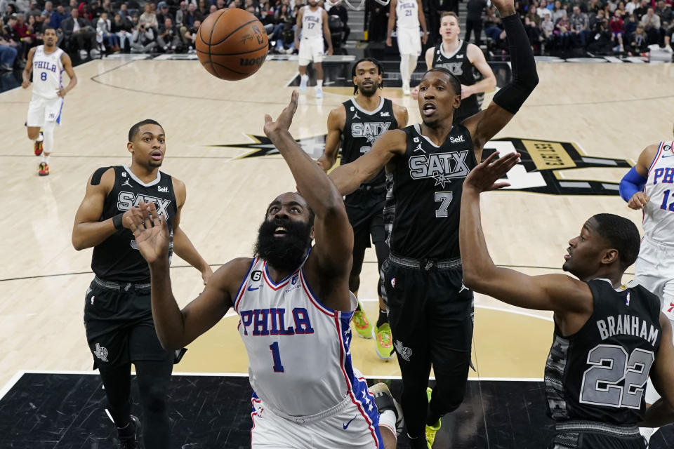 Philadelphia 76ers guard James Harden (1) drives to the basket past San Antonio Spurs guard Malaki Branham (22) during the first half of an NBA basketball game in San Antonio, Friday, Feb. 3, 2023. (AP Photo/Eric Gay)