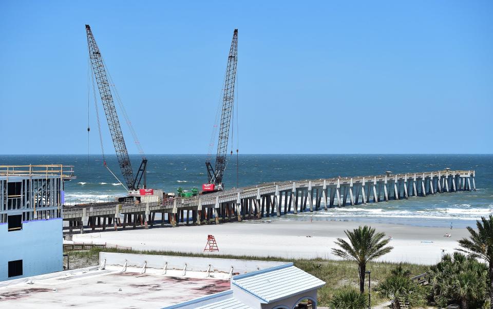 The repaired and replaced sections of the Jacksonville Beach Fishing Pier get closer to being completed on April 28 as cranes remove the working pier that was built along side of the main pier for its construction.