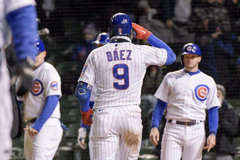 Chicago Cubs Javier Baez (9) celebrates his grand slam home run against the New York Mets during the sixth inning of a baseball game Wednesday, April 21, 2021, in Chicago. (AP Photo/Mark Black)