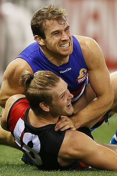 Stewart Crameri and Michael Hurley get physical in the clash between the Bulldogs and the Bombers.