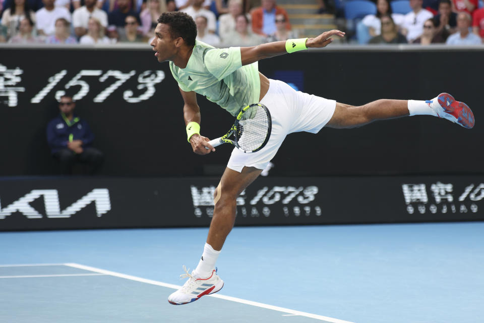 Felix Auger-Aliassime of Canada serves to Daniil Medvedev of Russia during their third round match at the Australian Open tennis championships at Melbourne Park, Melbourne, Australia, Saturday, Jan. 20, 2024. (AP Photo/Asanka Brendon Ratnayake)