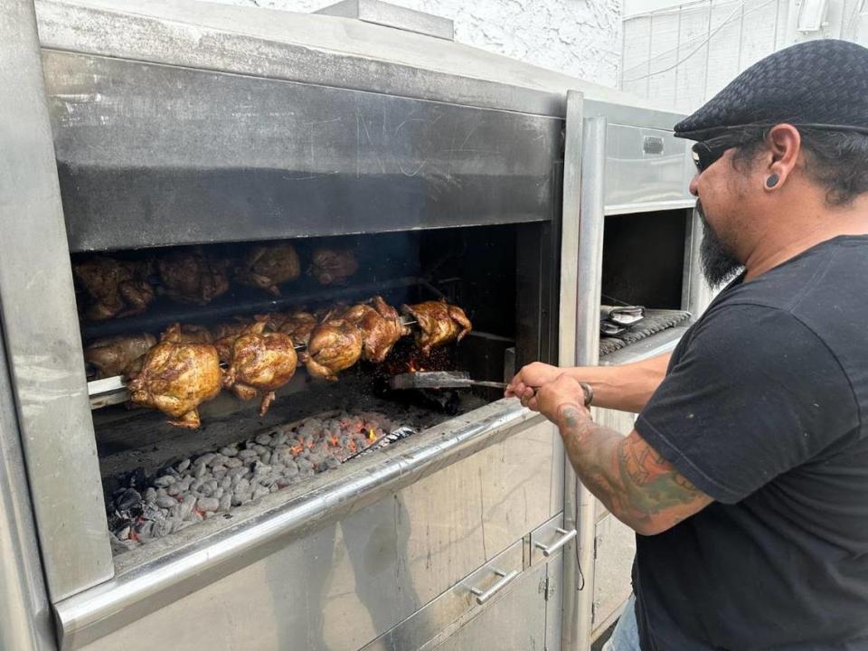 Cisco Huaman at his rotisserie oven. He marinates the chicken at least 24 hours and then grills it for an hour. Joyce Smith/jsmith@kcstar.com