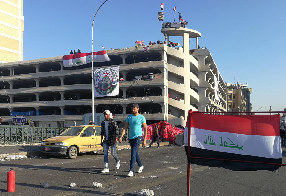 Anti-government protesters gather near the Sinak bridge leading to the Green Zone government areas during ongoing protests, in Baghdad, Iraq, Sunday, Nov. 17, 2019. (AP Photo/Khalid Mohammed)