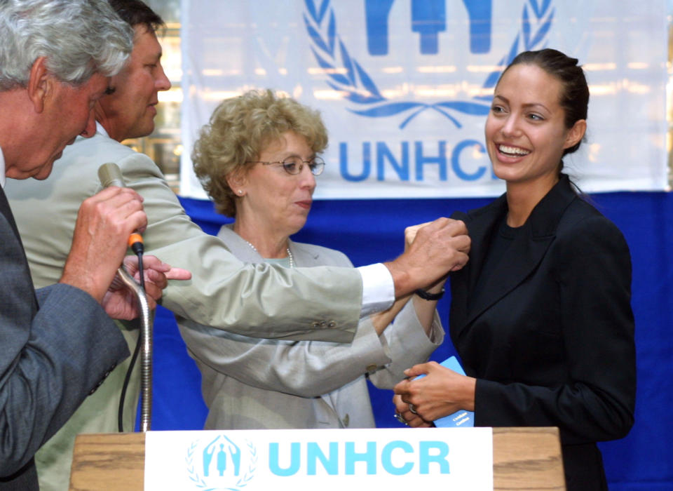 393727 01: American actress Angelina Jolie (R) smiles as she receives a pin from Mary-Anne Wyrsch, Deputy Commissioner of the United Nations High Commission for Refugees, August 27, 2001 during Jolie''s appointment ceremony as a goodwill ambassador for the UNHCR in Geneva, Switzerland. The UNHCR appoints stars as goodwill ambassadors in an effort to raise public awareness over the plight of refugees throughout the world. (Photo by Sean Gallup/Getty Images)