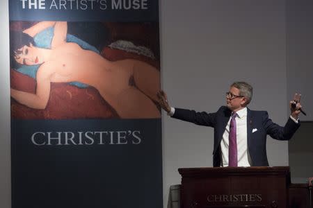 Christie's auctioneer Jussi Pylkkanen auctions Amedeo Modigliani's "Nu couche'" during a curated auction at Christie's entitled "The Artist's Muse" in Manhattan, New York November 9, 2015. REUTERS/Andrew Kelly