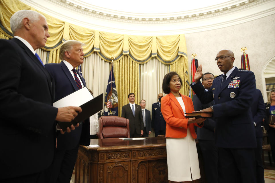 FILE - President Donald Trump watches as Vice President Mike Pence swears in Gen. CQ Brown, Jr. as Chief of Staff of the Air Force as his wife Sharene Guilford Brown holds the Bible in the Oval Office of the White House, Tuesday, Aug. 4, 2020, in Washington. President Joe Biden is expected to announce Brown, a history-making fighter pilot with recent experience countering China in the Pacific, to serve as the next chairman of the Joint Chiefs of Staff. If confirmed by the Senate, Brown would replace the current chairman of the Joint Chiefs of Staff, Army Gen. Mark Milley, whose term ends in October. (AP Photo/Alex Brandon, File)