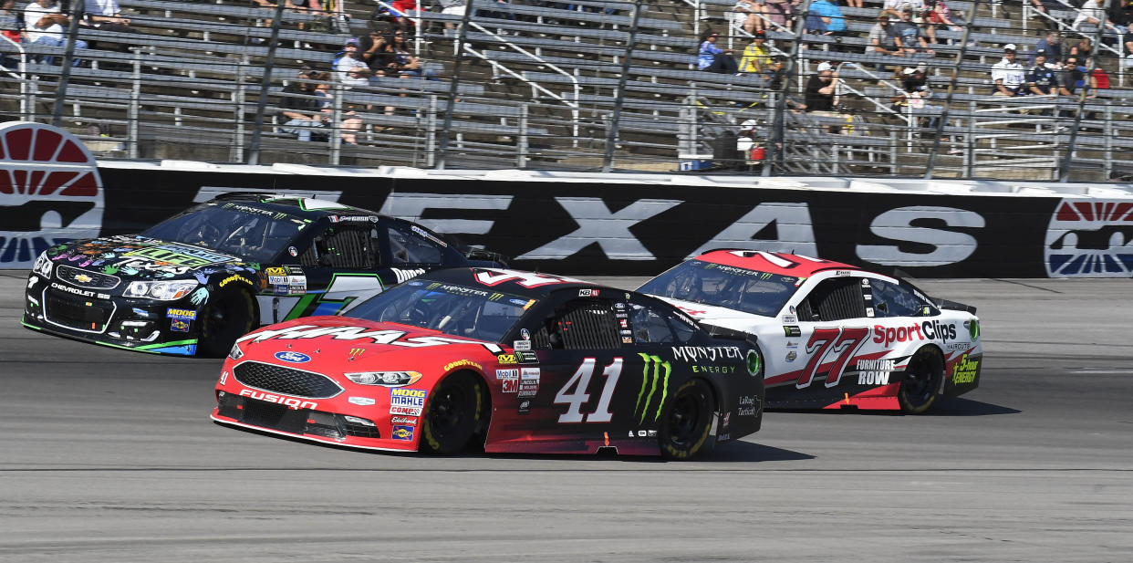 Kurt Busch (41) races against Erik Jones (77) and Joey Gase (7) during a NASCAR Cup Series auto race at Texas Motor Speedway in Fort Worth, Texas, Sunday, Nov. 5, 2017. (AP Photo/Larry Papke)