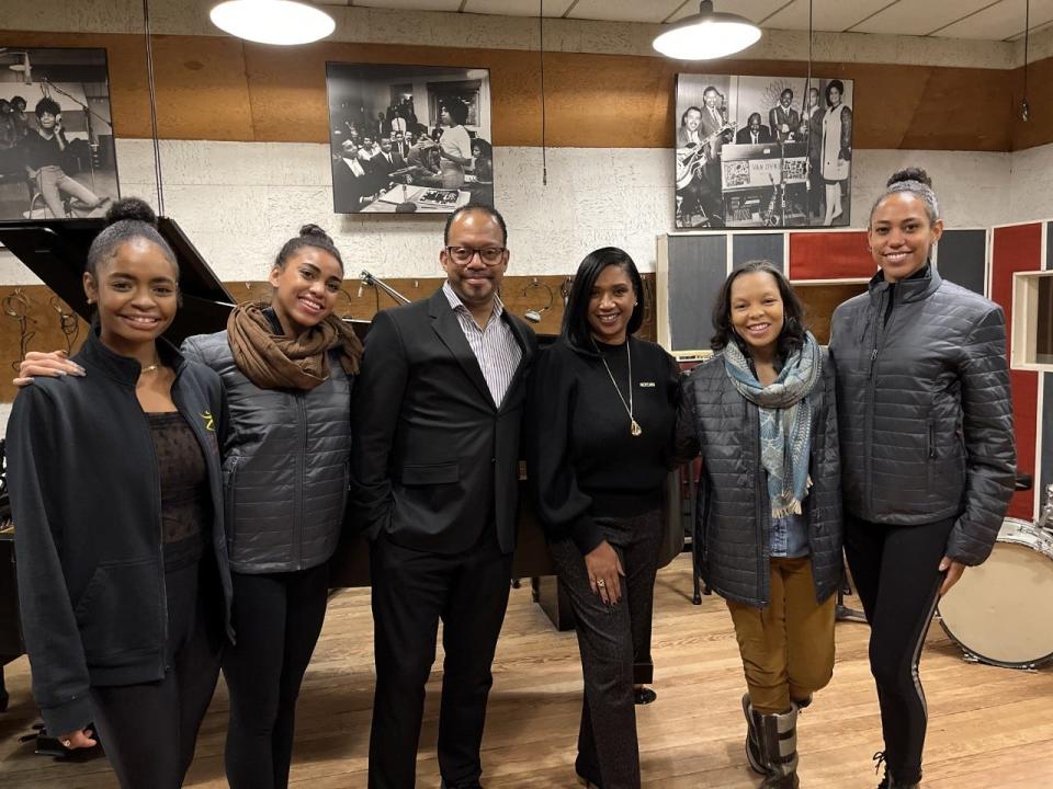 Dance Theatre of Harlem's Robert Garland and Anna Glass and the Motown Museum's Robin Terry (all center) are joined by dancers as they pose for a photo inside Motown's Studio A in Detroit on Dec. 14, 2021.