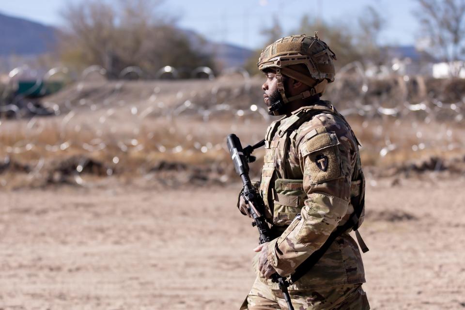 Texas National Guard troops guard a section of the Rio Grande where asylum-seekers had been crossing in large numbers in El Paso on Dec. 22.