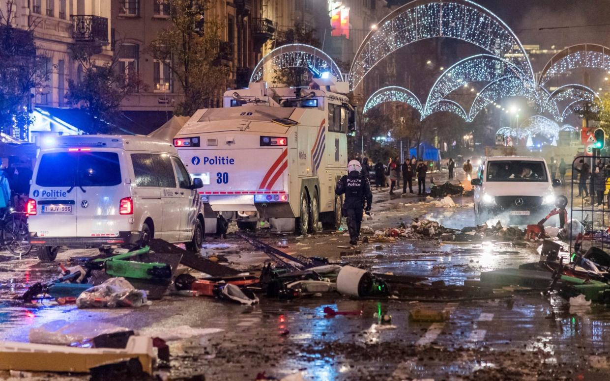 Police cars drive through a main boulevard in Brussels, Sunday