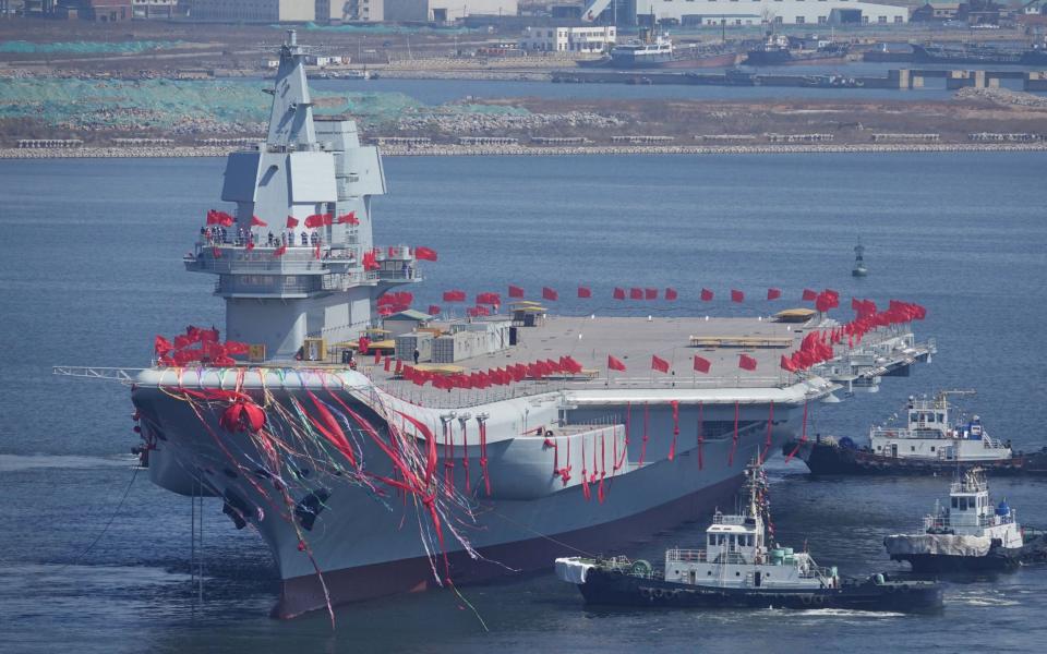 China's first domestically built aircraft carrier is seen during its launching ceremony in Dalian - Credit: REUTERS