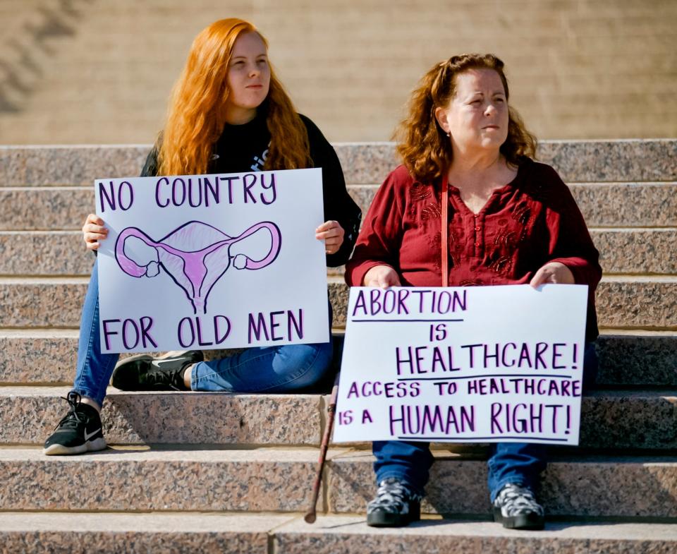 Sidney Barnett and her grandmother, Connie Barnett, hold signs May 3, 2022, as demonstrators gathered at the Oklahoma Capitol to protest as the U.S. Supreme Court appeared poised to overturn longstanding abortion protections and Oklahoma governor signs Texas-style abortion ban.