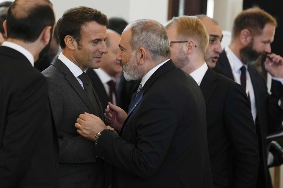 France's President Emmanuel Macron, second left, speaks with Armenia's Prime Minister Nikol Pasjinian, center, during a meeting of the European Political Community at Prague Castle in Prague, Czech Republic, Thursday, Oct 6, 2022. Leaders from around 44 countries are gathering Thursday to launch a "European Political Community" aimed at boosting security and economic prosperity across the continent, with Russia the one major European power not invited. (AP Photo/Alastair Grant, Pool)