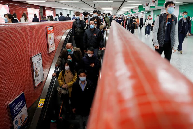 Passengers wear mask to prevent a new coronavirus outbreak at a Mass Transit Railway (MTR) subway train station in Hong Kong