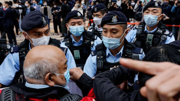 PHOTO: Supporters are surrounded by police outside the West Kowloon Magistrates' Courts building during the hearing of the 47 pro-democracy activists charged with conspiracy to commit subversion under the national security law, in Hong Kong, Feb. 6, 2023. (Tyrone Siu/Reuters)