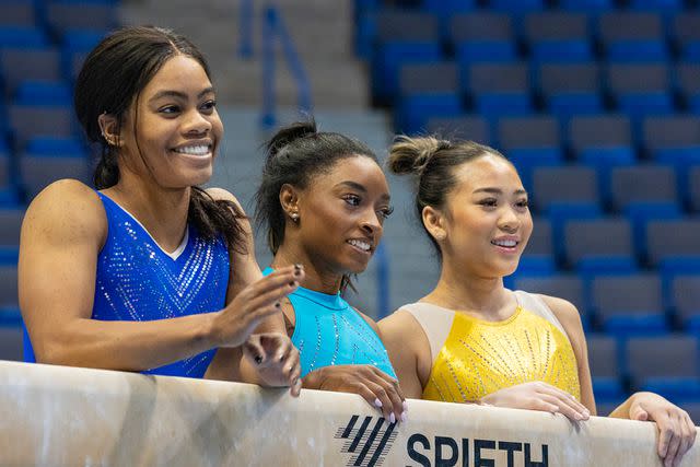 <p>Tim Clayton/Corbis via Getty </p> From Left: Gabby Douglas, Simone Biles and Suni Lee on May 17, 2024