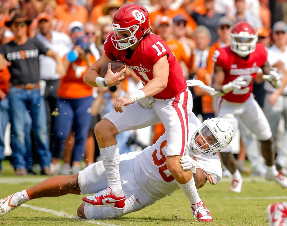 Texas Longhorns defensive lineman Byron Murphy II (90) brings down Oklahoma Sooners quarterback Davis Beville (11) during the Red River Showdown college football game between the University of Oklahoma (OU) and Texas at the Cotton Bowl in Dallas, Saturday, Oct. 8, 2022.  Texas won 49-0.