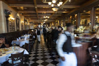 Waiters come and go at Ceasar's restaurant Thursday, June 27, 2024, in Tijuana, Mexico. Caesar salad has something to celebrate: It's turning 100. Italian immigrant Caesar Cardini is said to have invented the dish on July 4, 1924, at his restaurant, Caesar's Place, in Tijuana, Mexico. (AP Photo/Gregory Bull)