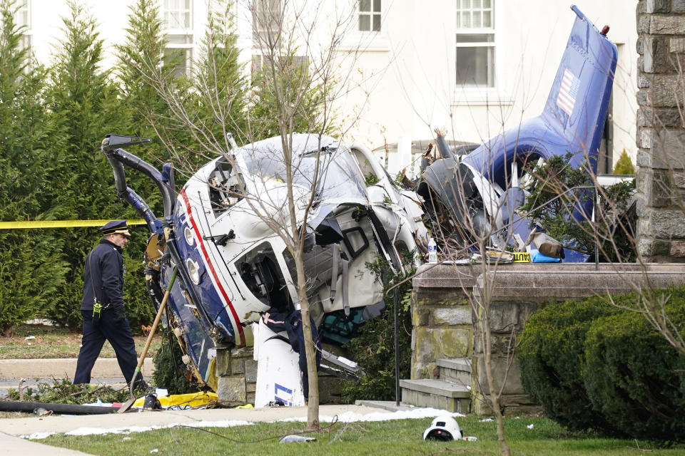 A medical helicopter rests next to the Drexel Hill United Methodist Church after it crashed the day before in the Drexel Hill section of Upper Darby, Pa, Wednesday, Jan. 12, 2022. Authorities and a witness say a pilot crash landed a medical helicopter without casualties in a residential area of suburban Philadelphia, miraculously avoiding a web of power lines and buildings as the aircraft fluttered, hit the street and slid into bushes outside a church. (AP Photo/Matt Rourke)