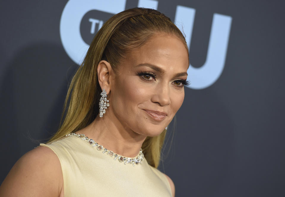 FILE - In this Jan. 12, 2020 file photo, Jennifer Lopez arrives at the 25th annual Critics' Choice Awards at the Barker Hangar in Santa Monica, Calif. Backed by an international concert hosted by Selena Gomez and headlined by Lopez, Global Citizen is unveiling an ambitious campaign to help medical workers in the world’s poorest countries quickly receive COVID-19 vaccines. (Photo by Jordan Strauss/Invision/AP)