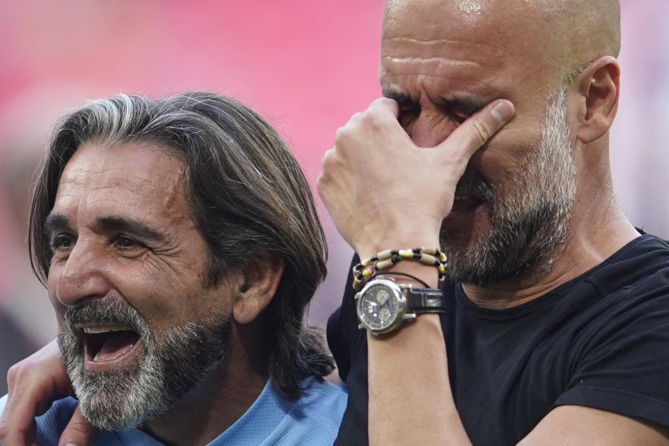 Manchester City's head coach Pep Guardiola, right, gestures as celebrates winning the English FA Cup final soccer match between Manchester City and Manchester United at Wembley Stadium in London, Saturday, June 3, 2023. Manchester City won 2-1. (AP Photo/Dave Thompson)