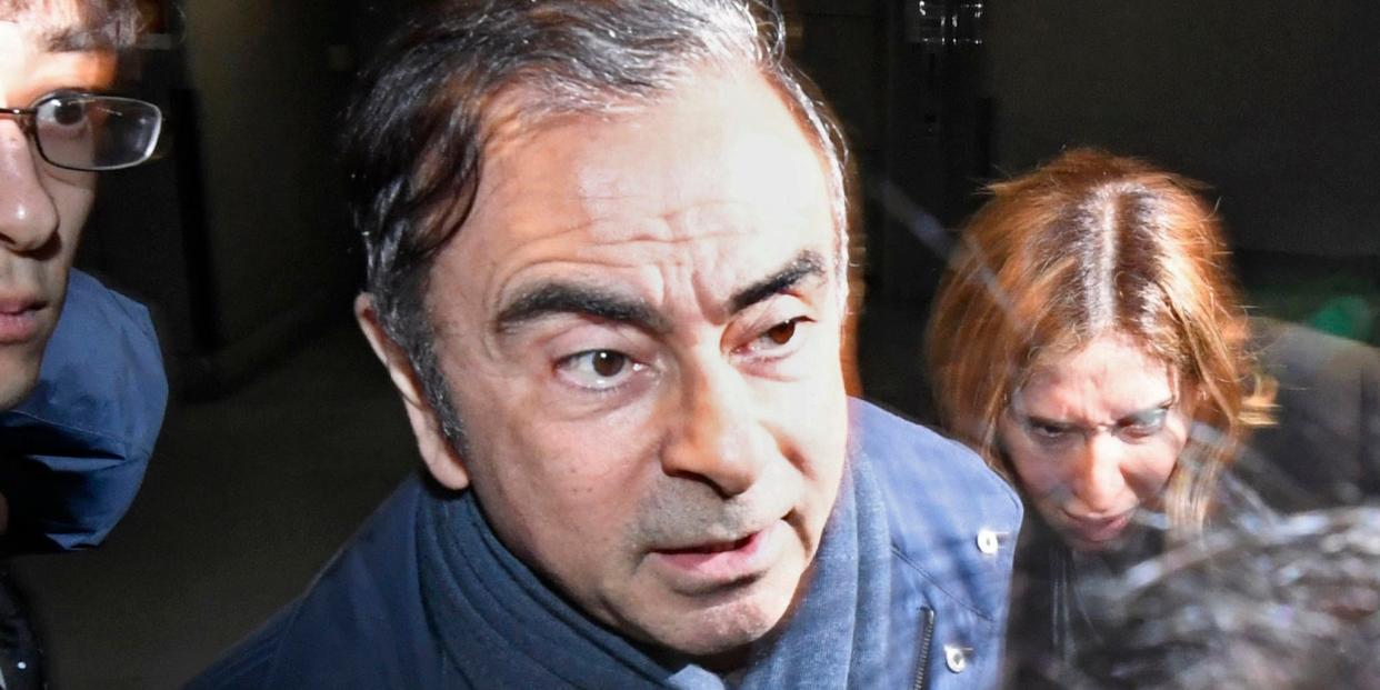 FILE - In this April 3, 2019, file photo, former Nissan Chairman Carlos Ghosn, center, leaves his lawyer's office in Tokyo. Nissan Chief Executive Hiroto Saikawa has apologized to shareholders for the unfolding scandal at the Japanese automaker and asked for their approval to oust from the board former Chairman Ghosn, who has been arrested on financial misconduct charges. Saikawa and other Nissan Motor Co. executives bowed deeply at a Tokyo hotel Monday, April 8, 2019, where the extraordinary shareholders' meeting was being held. (Sadayuki Goto/Kyodo News via AP, File)