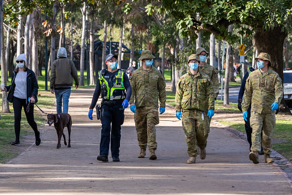 Australian Defence Force (ADF) personnel and Protective service officers are seen on patrol at the Tan running track in Melbourne, Australia.  