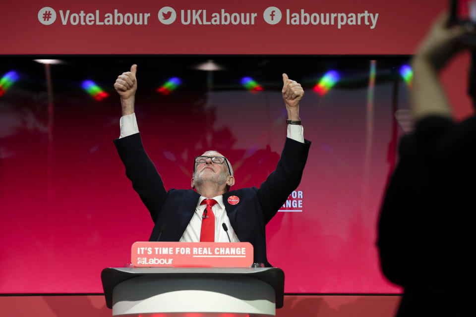 Jeremy Corbyn, Leader of Britain's opposition Labour Party gestures on stage at the launch of Labour's General Election manifesto, at Birmingham City University, England, Thursday, Nov. 21, 2019. Britain goes to the polls on Dec. 12. (AP Photo/Kirsty Wigglesworth)