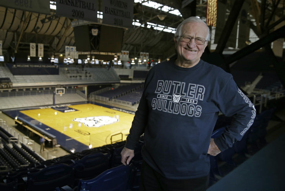 FILE - In this Dec. 20, 2016, file photo, Bobby Plump, star of the 1954 Milan state championship basketball team featured in the movie "Hoosiers," poses in Hinkle Fieldhouse in Indianapolis. "Hoosiers" was voted the No. 1 sports movie of all time by the sports staff of The Associated Press. (AP Photo/Michael Conroy, File)