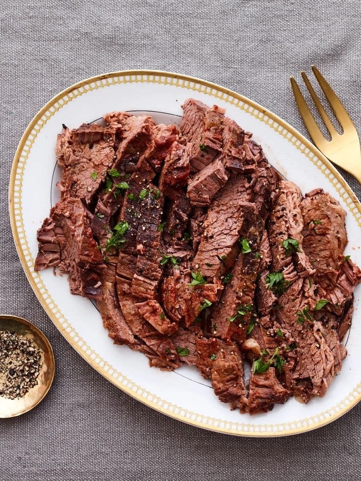 Overnight beef brisket sliced on a platter.