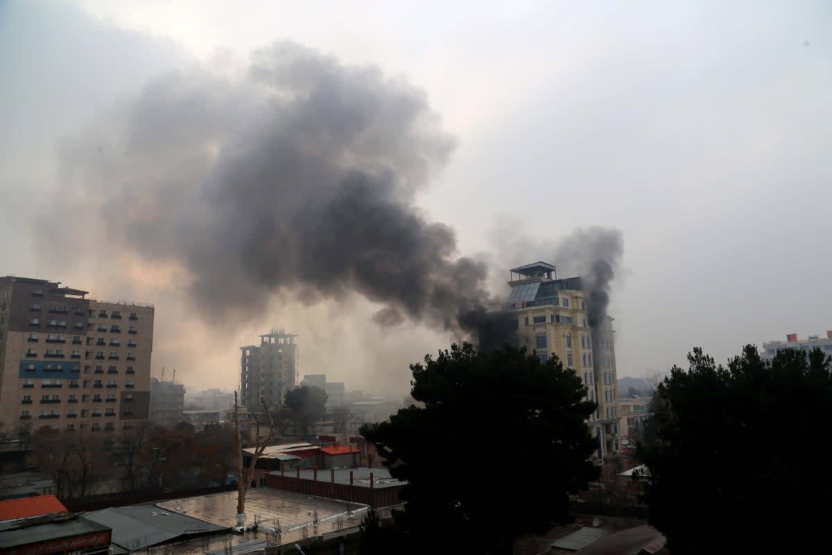 Smoke billows from a hotel after an attack in Kabul, Afghanistan on 12 December (EPA)