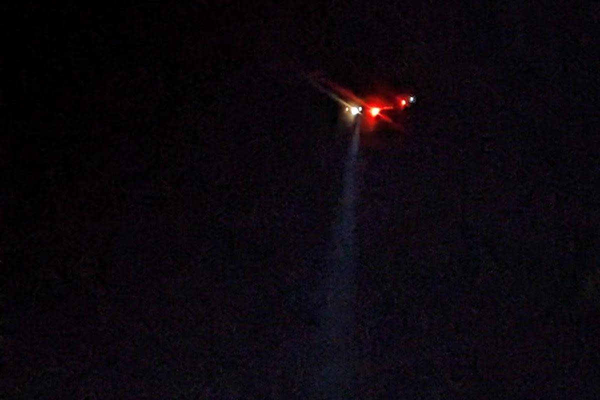 A Solent Coastguard helicopter using a searchlight over East Cowes harbour last night (Saturday). <i>(Image: County Press)</i>