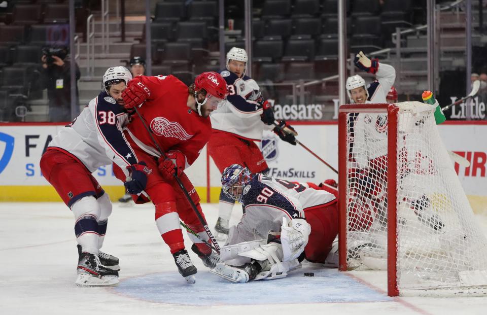 Detroit Red Wings center Michael Rasmussen (27) scores the game winner against Columbus Blue Jackets goaltender Elvis Merzlikins (90) during third period action Sunday, March 28, 2021 at Little Caesars Arena in Detroit.