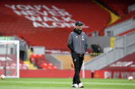 Liverpool's manager Jurgen Klopp walks on the pitch during warmup before the English Premier League soccer match between Liverpool and Aston Villa at Anfield Stadium in Liverpool, England, Sunday, July 5, 2020. (Paul Ellis/Pool via AP)
