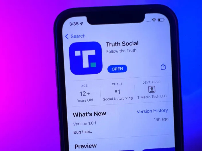 A phone displaying Donald Trump's Truth Social app in the Apple App Store.