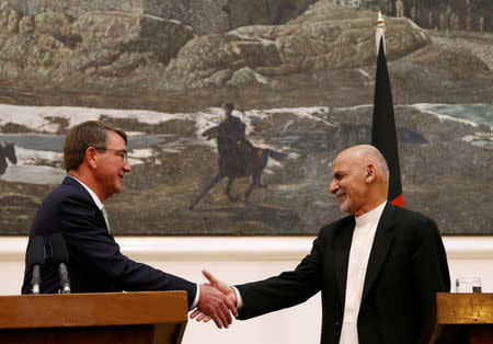 U.S Defense Secretary Ashton Carter (L) shakes hands with Afghanistan's President Ashraf Ghani during a news conference in Kabul, Afghanistan July 12, 2016. REUTERS/Mohammad Ismail