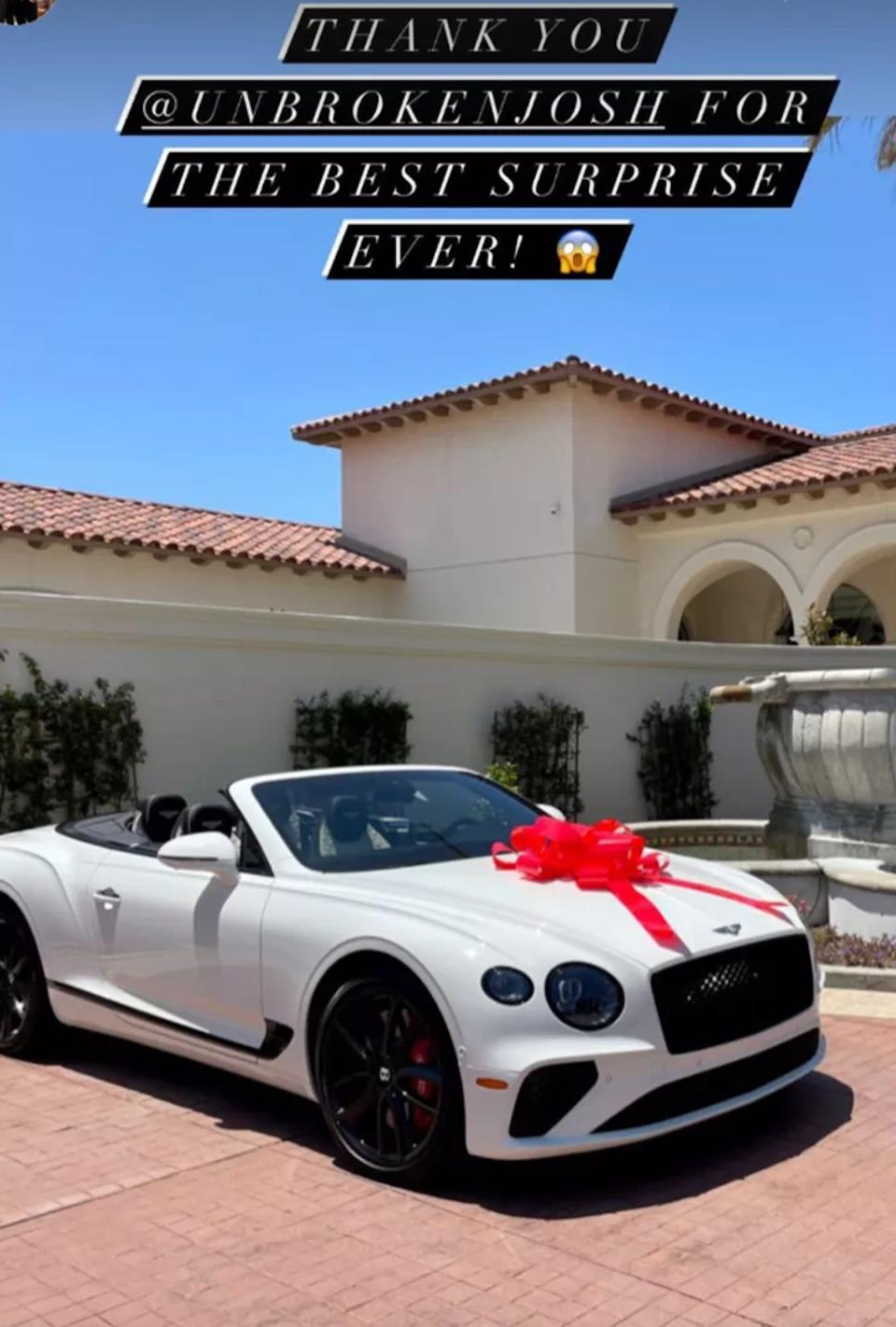 A screenshot of Christina Hall's Instagram story of a white convertible with a bow on it.